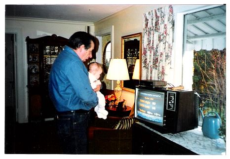1987 - Rob introducing granddaughter Katie to the Financial News Network.jpg